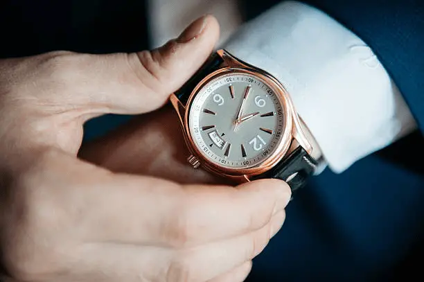 a man adjusting a watch, one of the trendiest watches