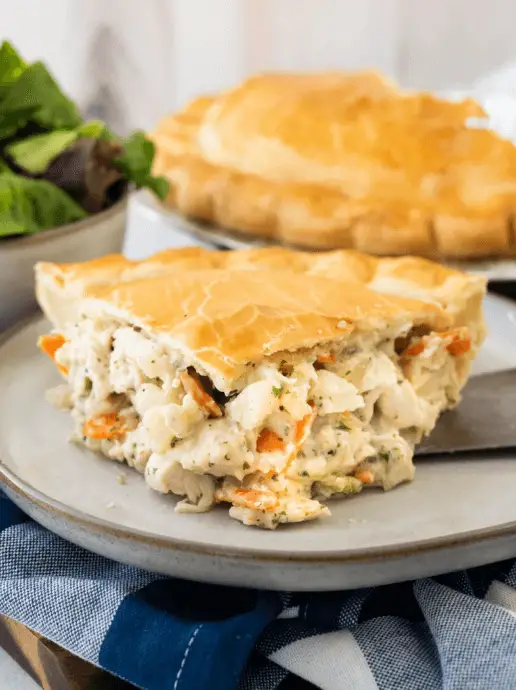 Slice of chicken pot pie showing the inside filled with creamy chicken
