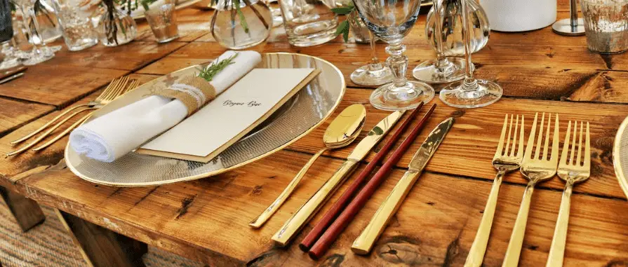 gold fork and knives on kitchen table showing unique utensils.  kitchen decoration ideas.