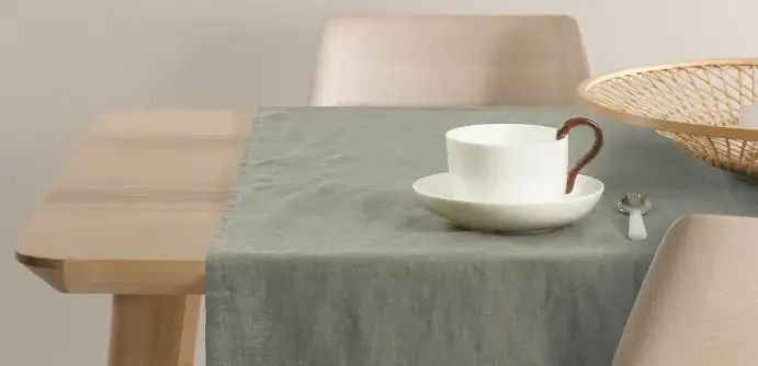 grey table runner showing different ways you can display your kitchen table decoration.