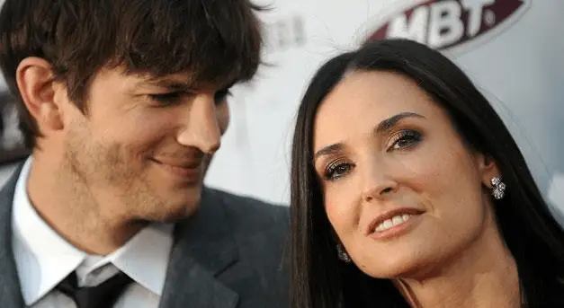 ASHTON Kutcher and Demi Moore on the red carpet.  Ashton smiling at his older girlfriend Demi