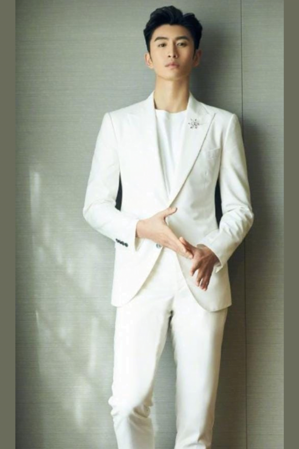 classic mens all white suit for the summer.  picture of man posing in all white suit jacket and pants