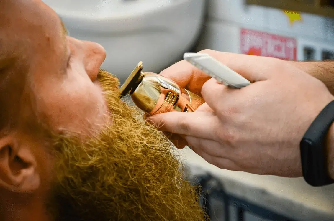 barber trimming around a mustache how to trim a beard