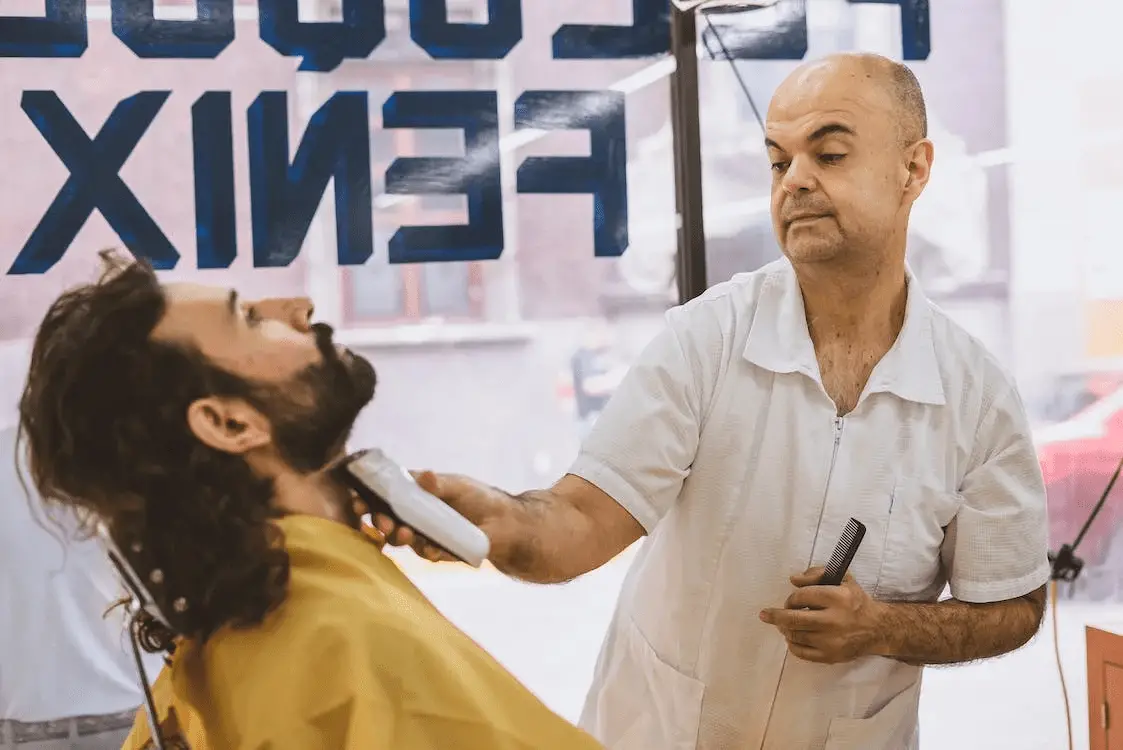 barber trimming a clients neckline how to trim a beard