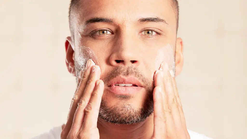 man using a men's face scrub